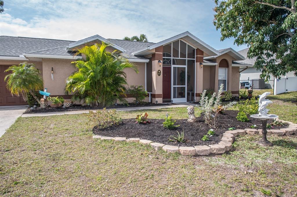 a front view of a house with garden