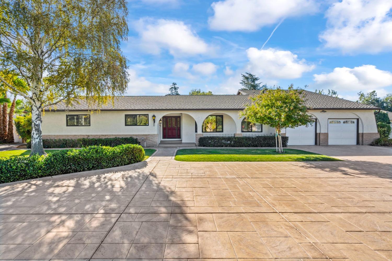 a view of house with yard and entertaining space