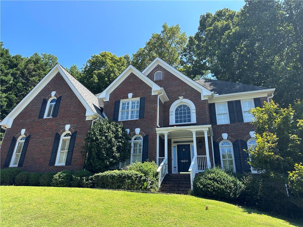 a front view of a house with garden