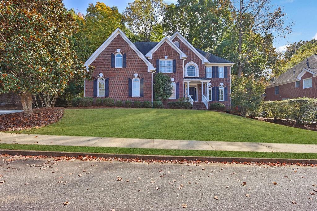 a front view of a house with a yard and garage