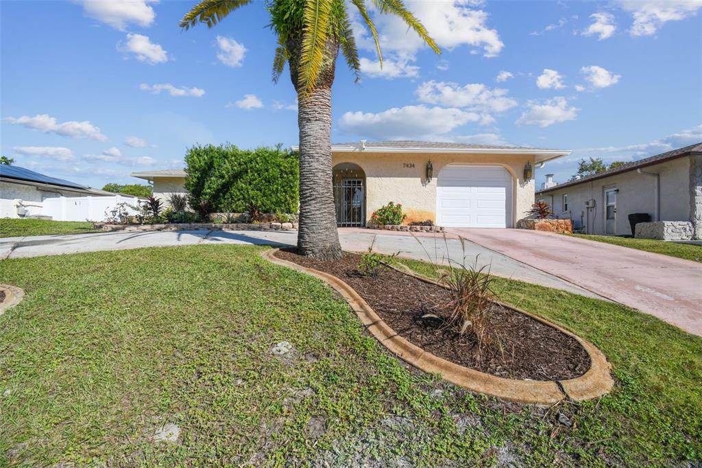 a view of a house with a swimming pool and a yard