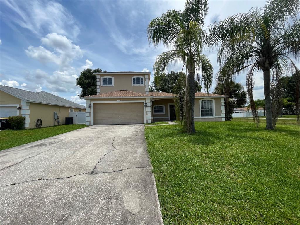 a front view of house with yard and green space