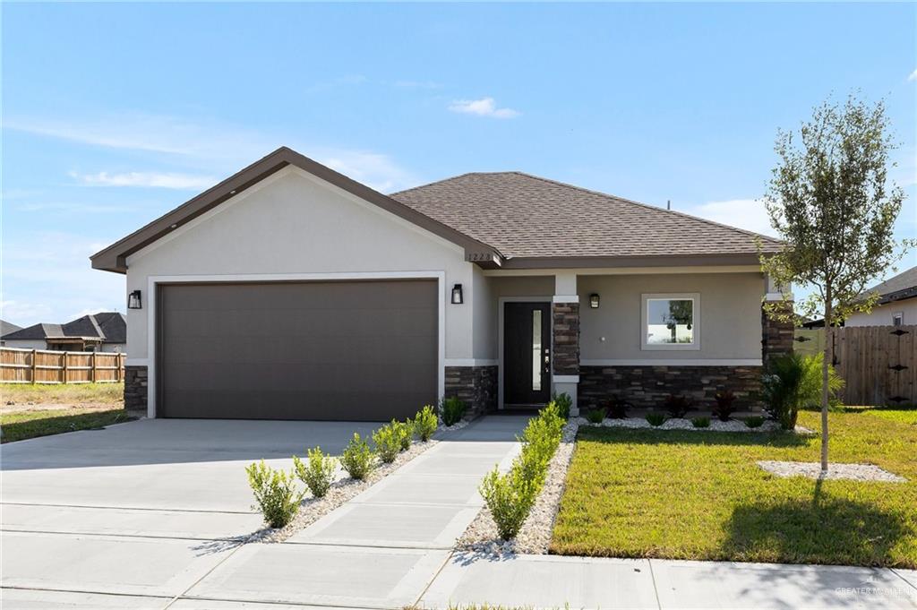 View of front facade with a garage and a front yard