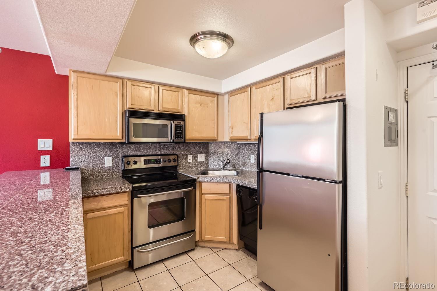 a kitchen with a refrigerator stove and microwave