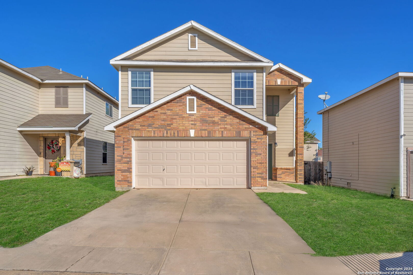 a front view of a house with a yard and garage