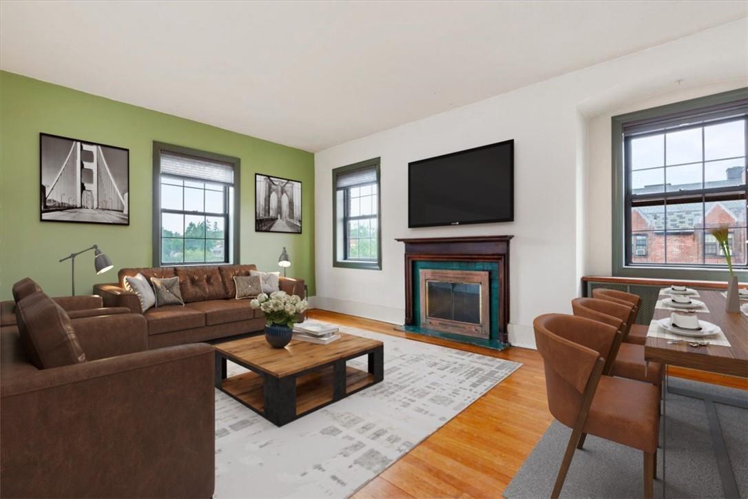 a living room with fireplace furniture and a flat screen tv