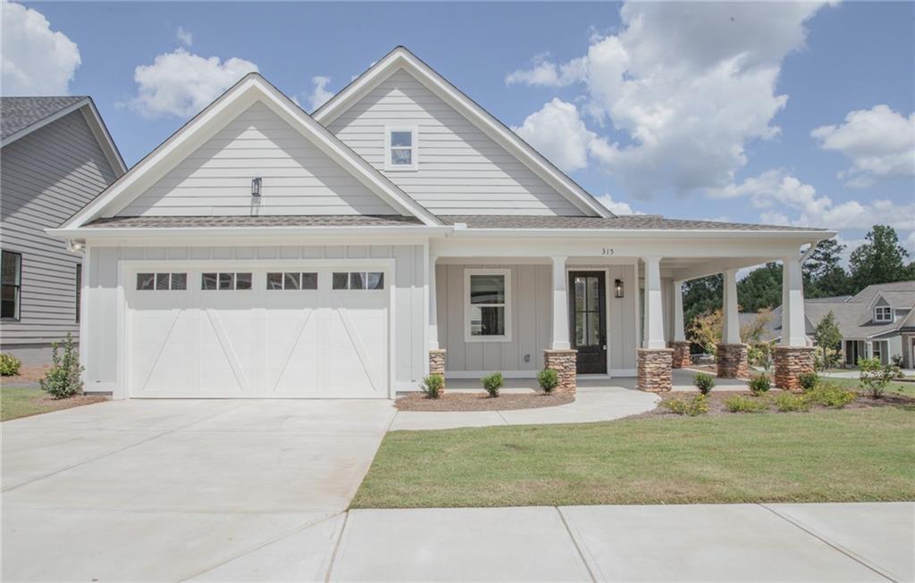 a view of house with yard and outdoor seating