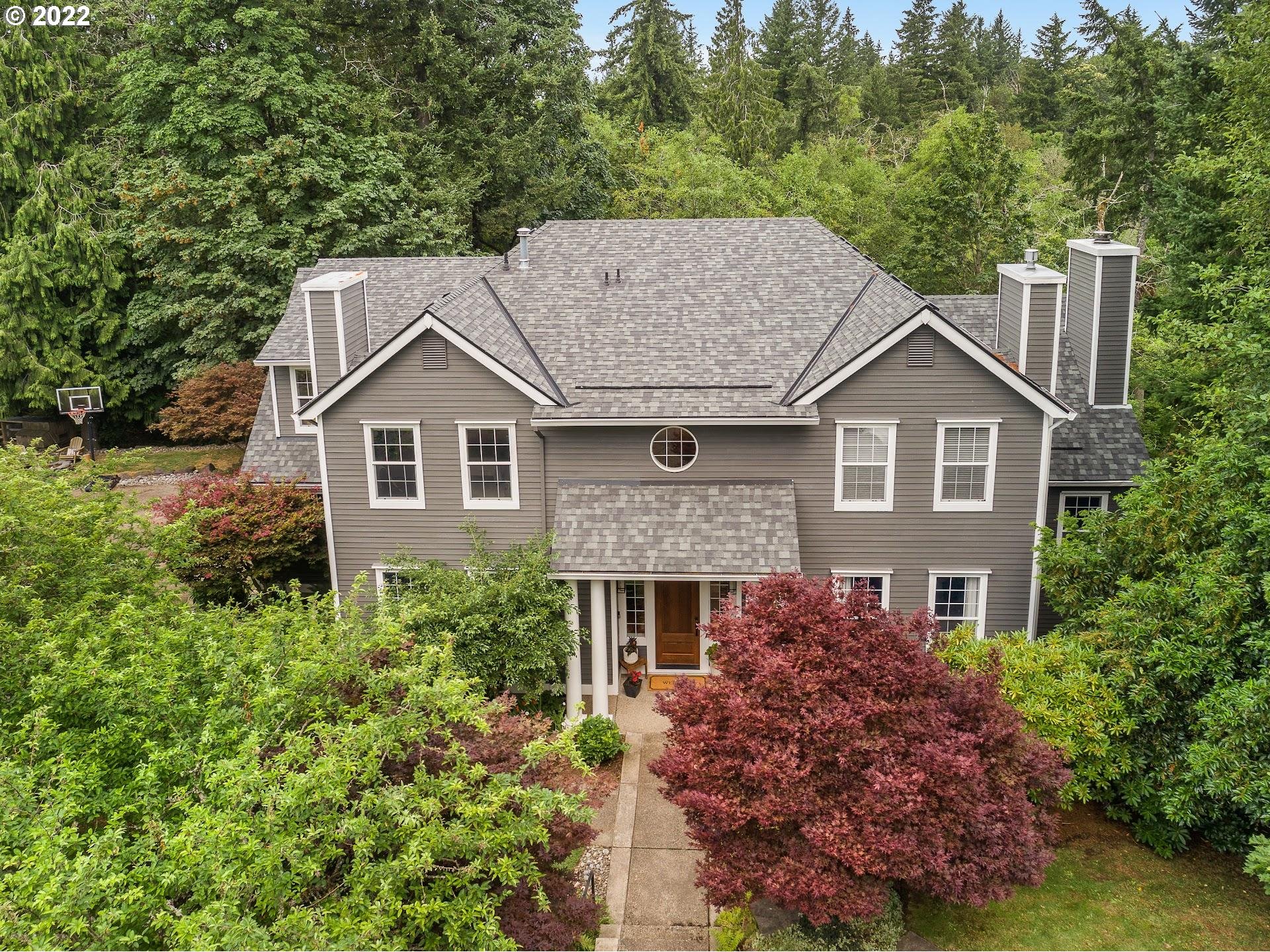 a aerial view of a house with a yard and potted plants