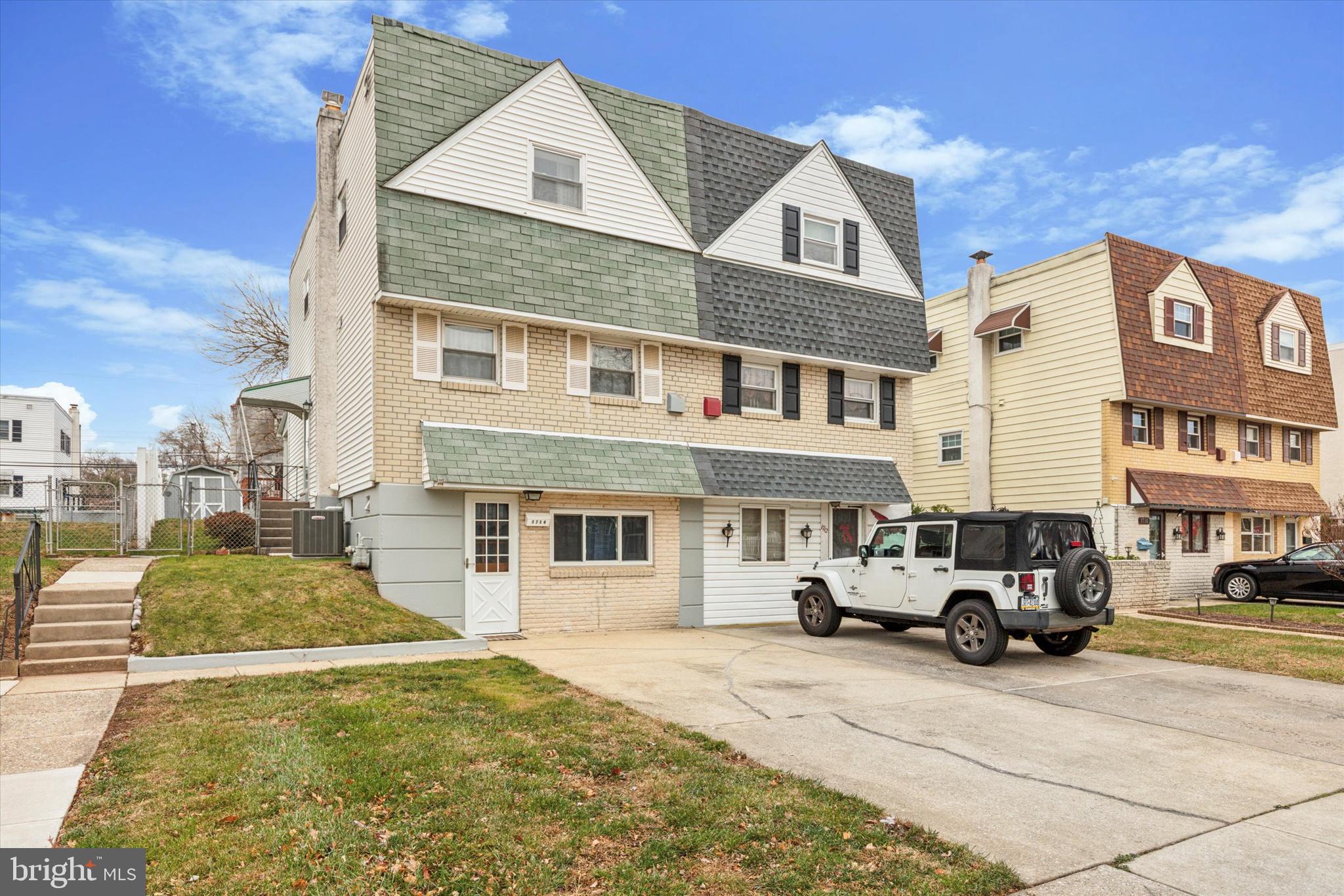 a front view of a residential apartment building with a yard