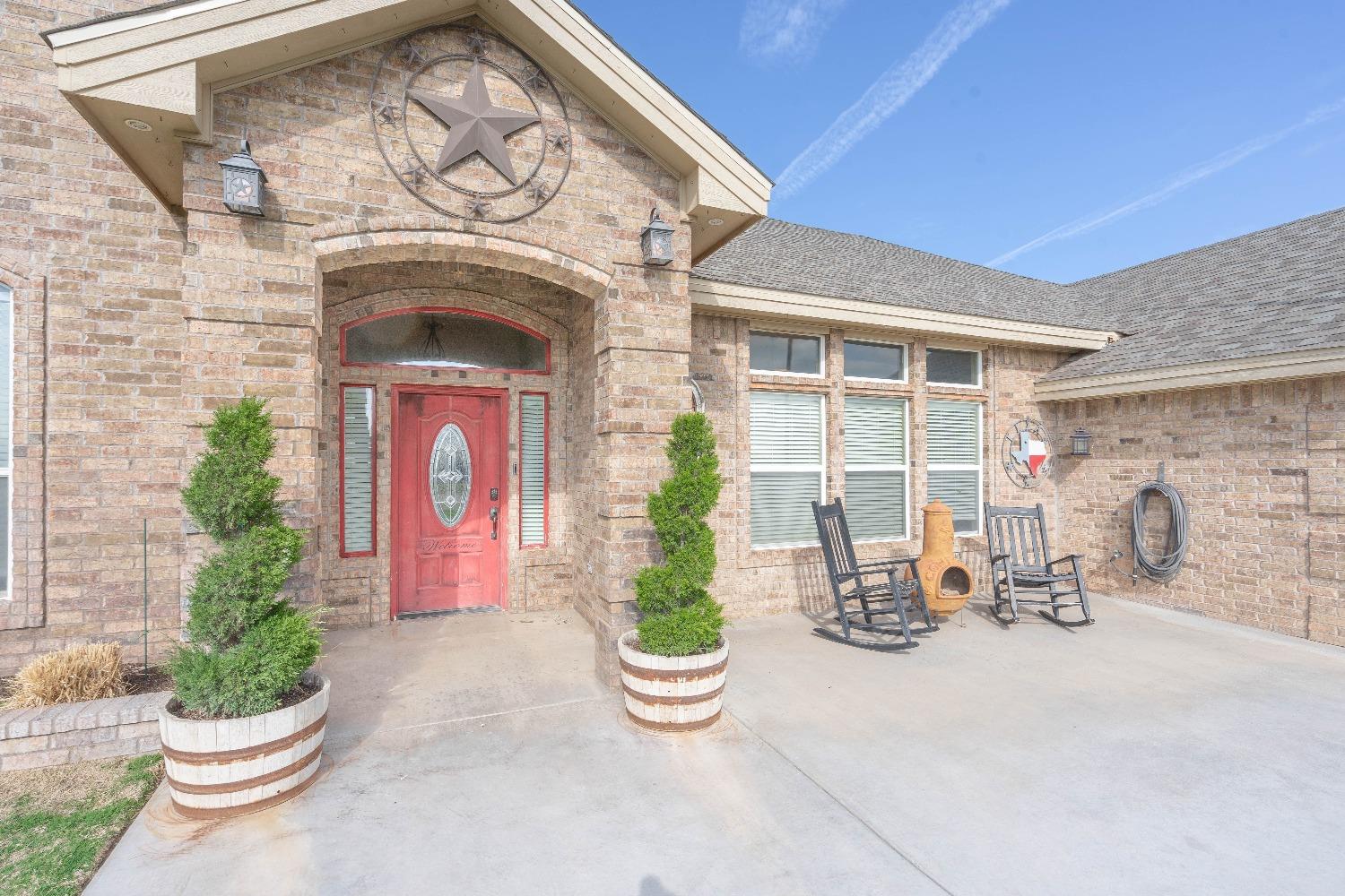 a front view of a house with outdoor seating