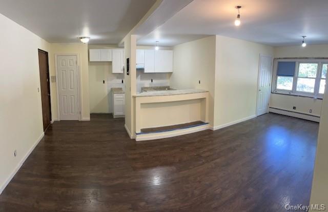 a view of a kitchen with a sink and a refrigerator