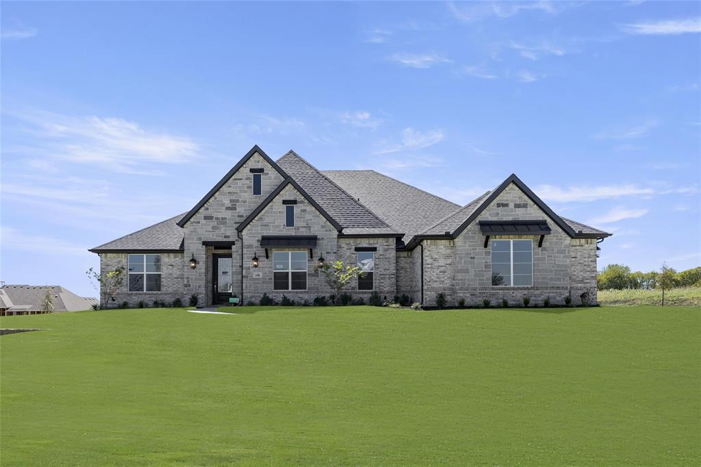 a front view of house with yard and green space