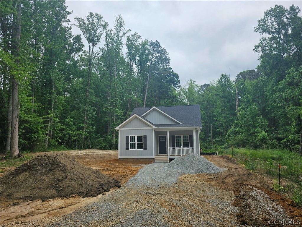 a front view of a house with yard and green space