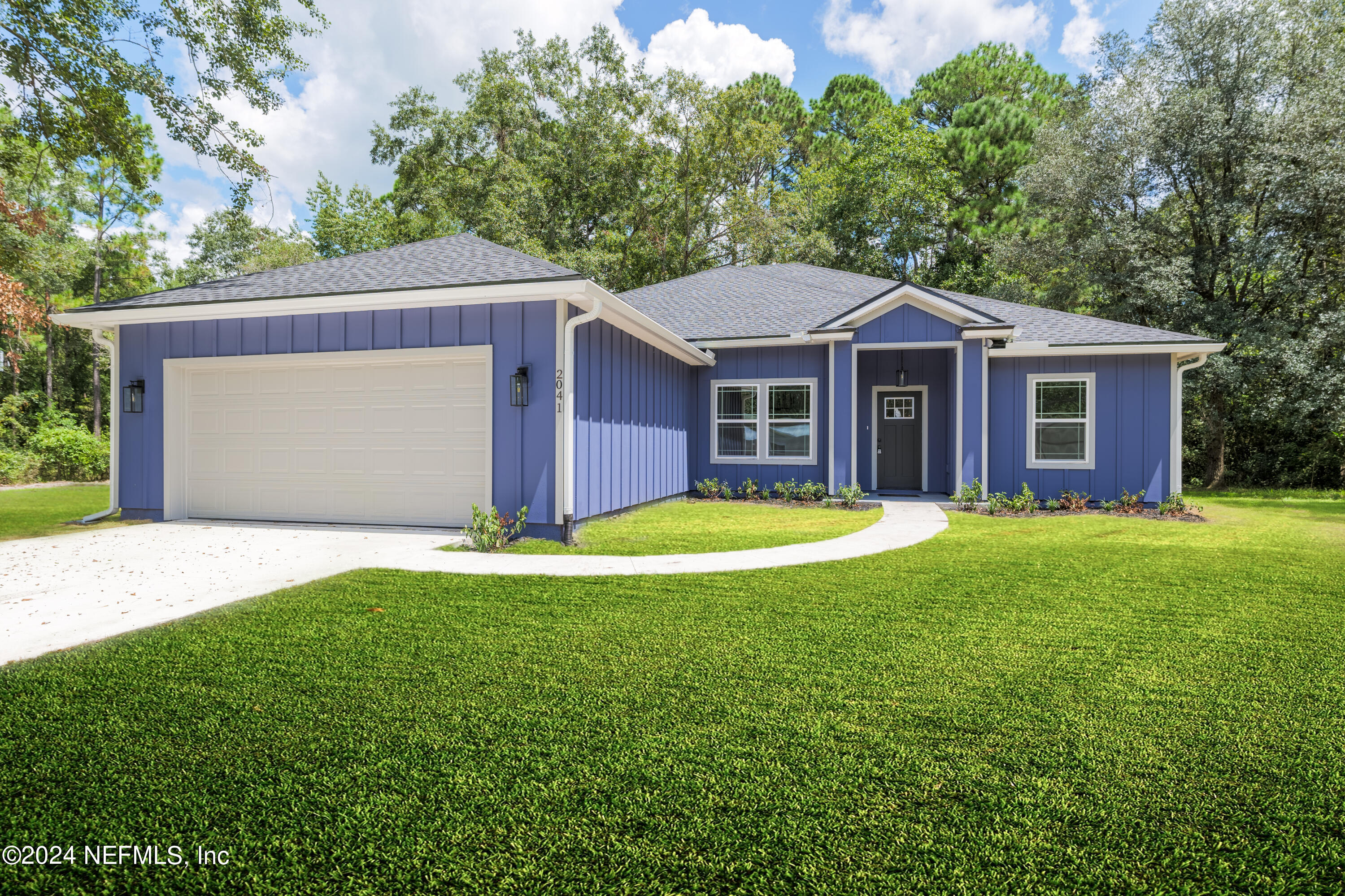 a front view of house with yard and green space