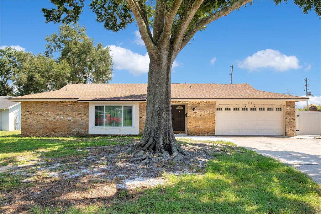 a view of a house with a yard