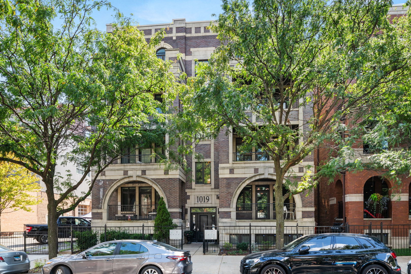 a front view of a building with trees