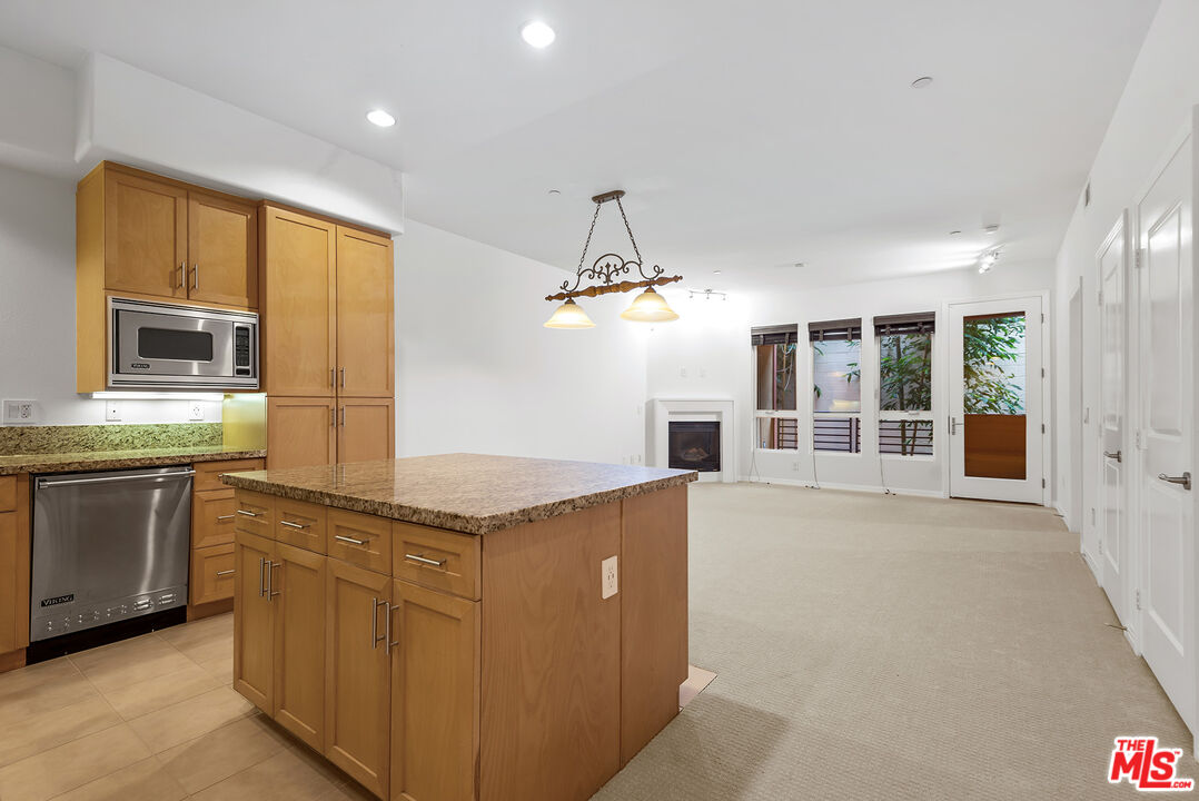 a kitchen with stainless steel appliances granite countertop a stove and a sink