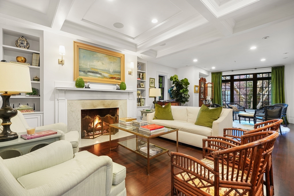 a living room with furniture fireplace and a large window