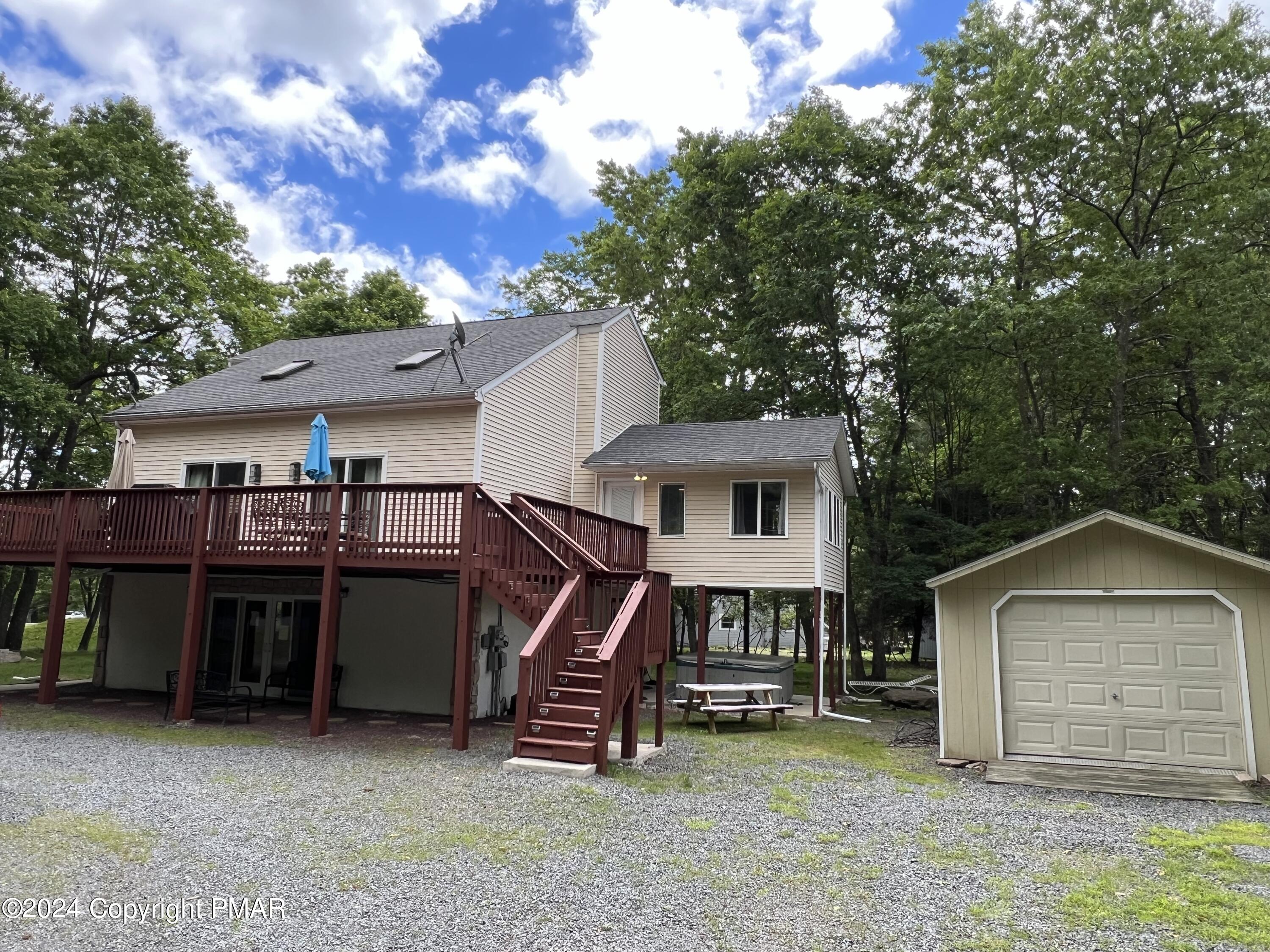 a view of a house with a yard and sitting area