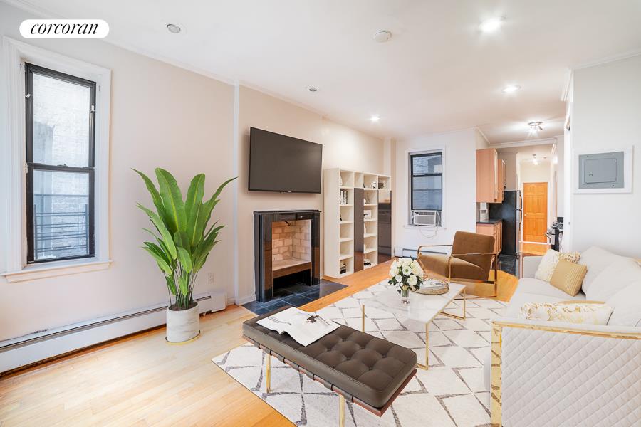 a living room with furniture a flat screen tv and a fireplace