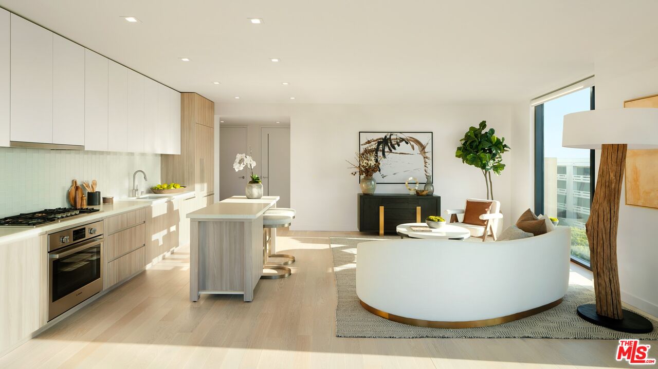 a living room with furniture a fireplace and a kitchen view