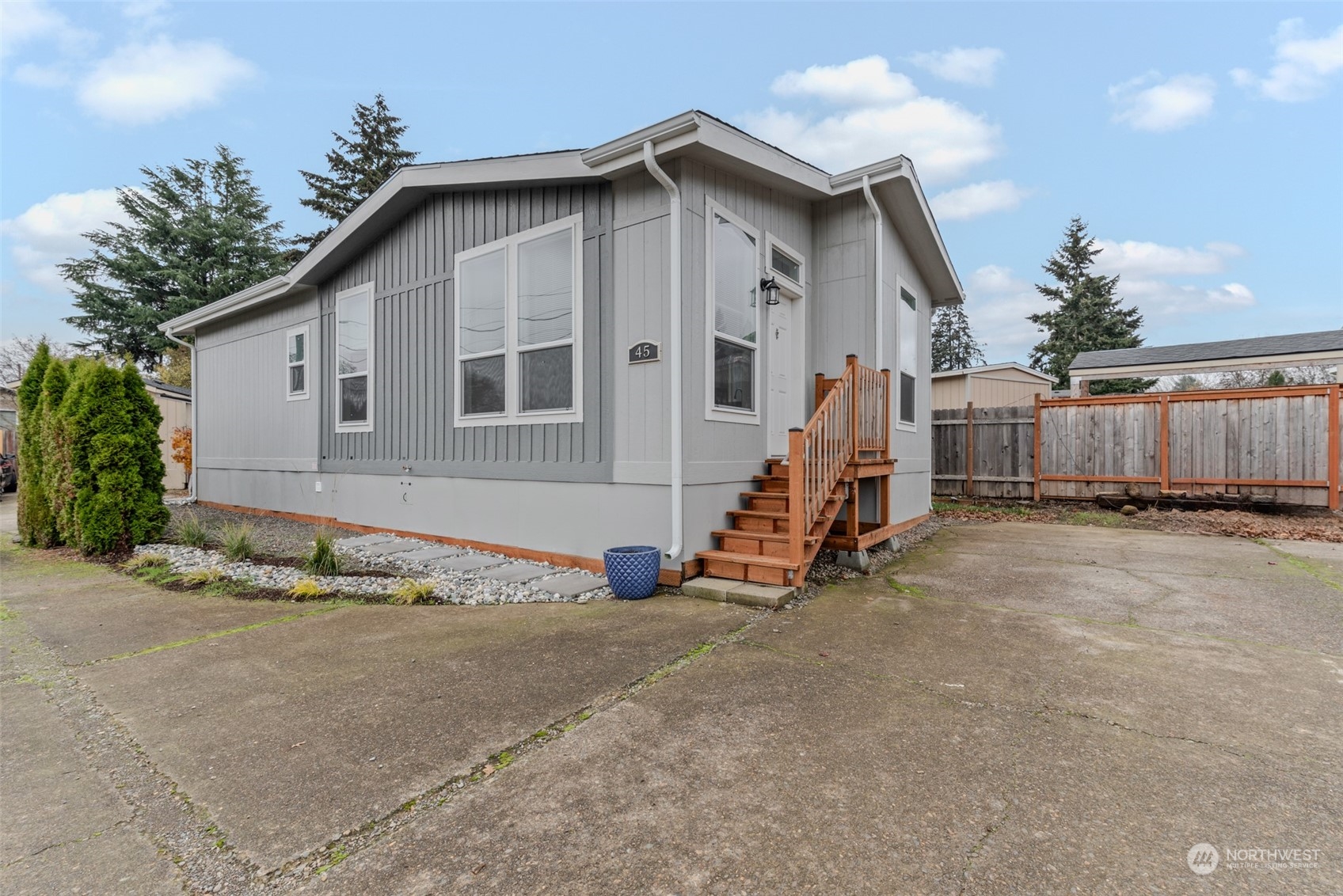 a view of a house with wooden fence