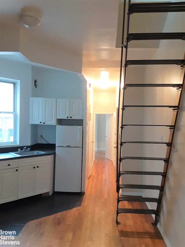 a kitchen with a sink and wooden cabinets