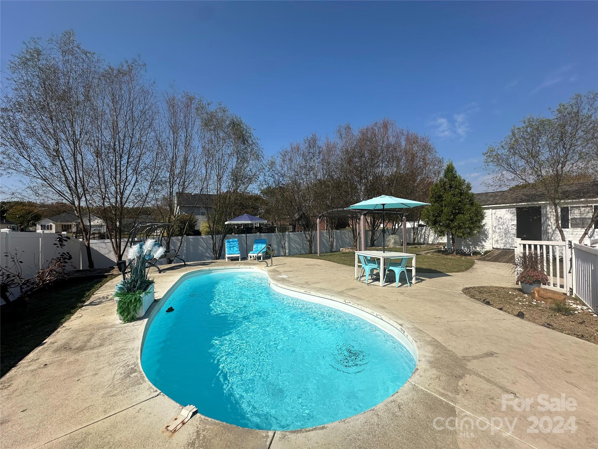 a swimming pool with outdoor seating yard and barbeque oven