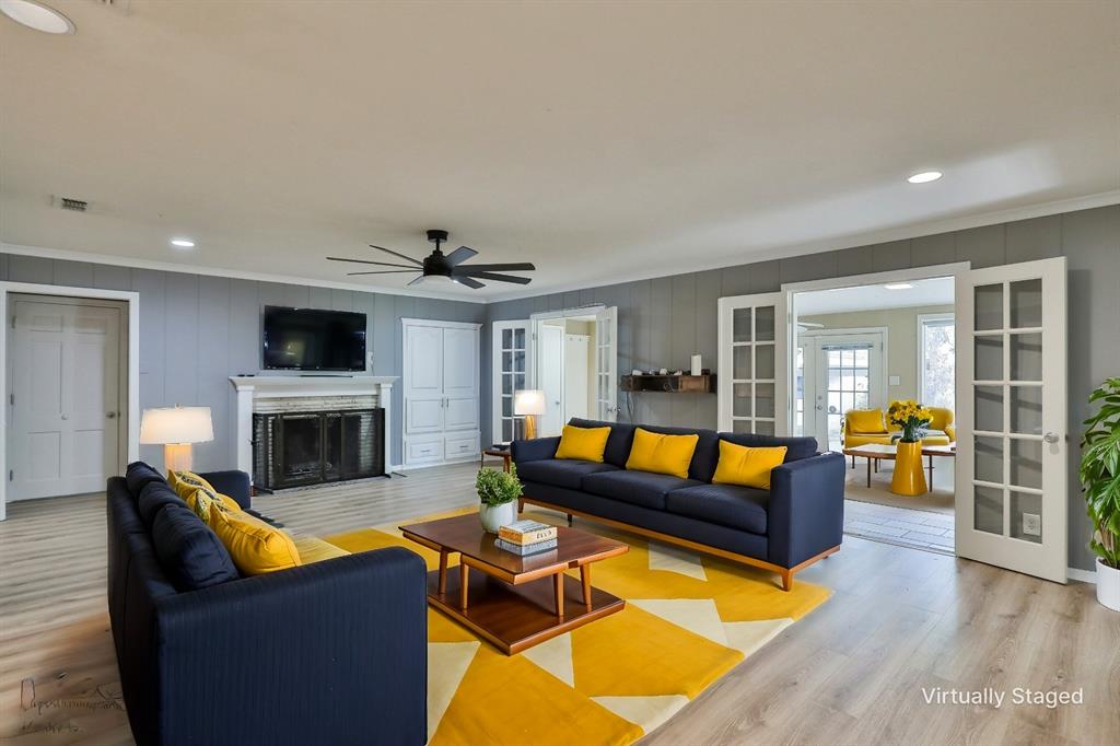 a living room with furniture a fireplace and a flat screen tv