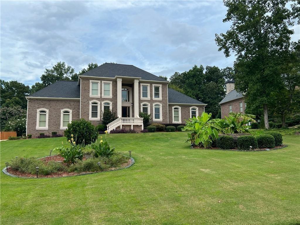 a front view of a house with a yard