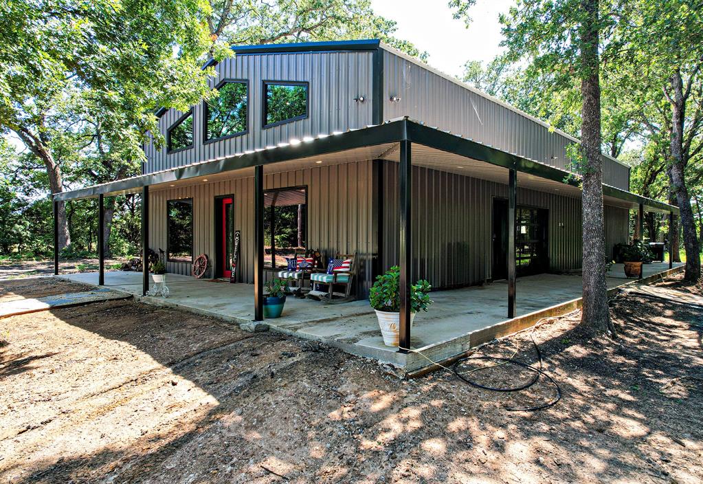 a view of a house with backyard porch and sitting area