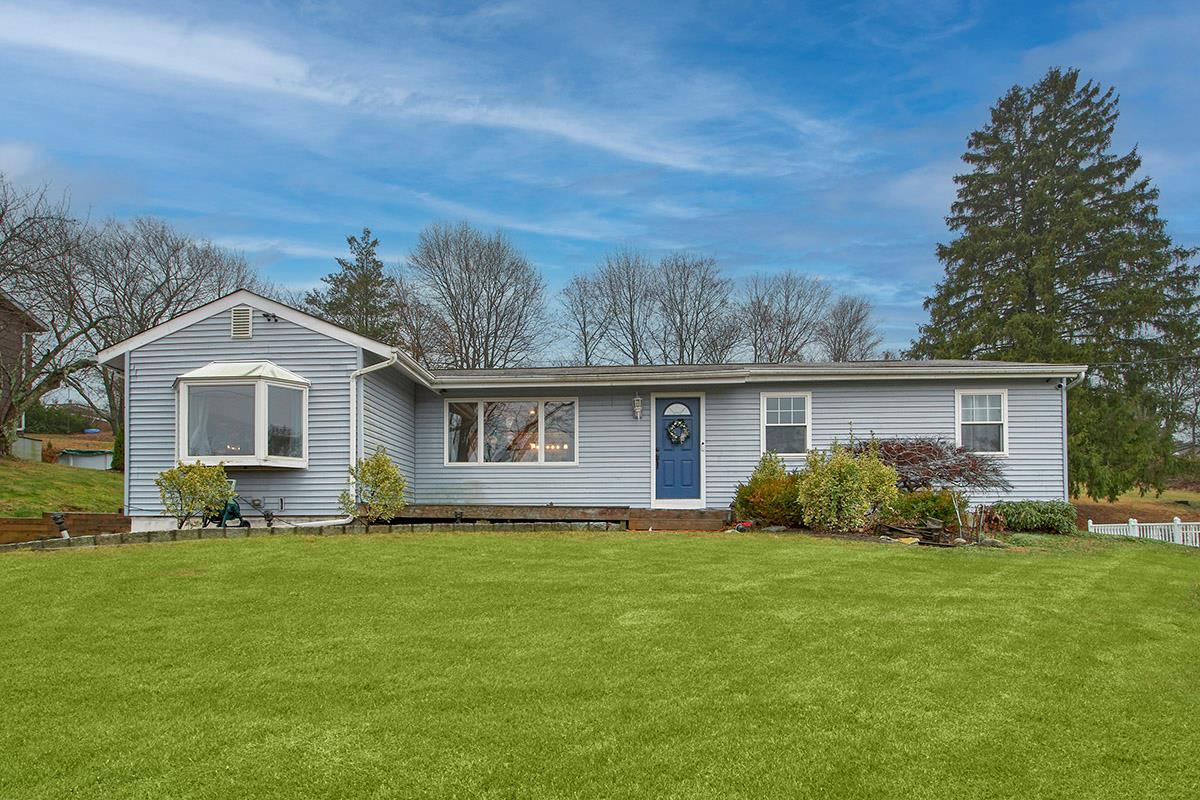 a front view of house with yard and green space