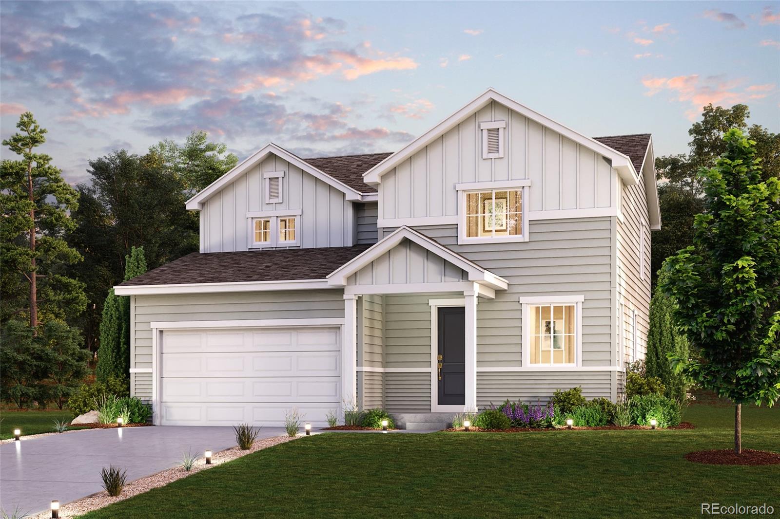 a front view of a house with a yard and garage