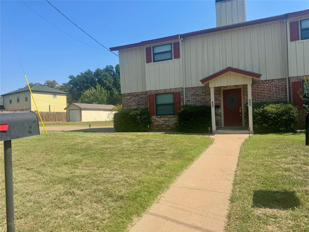 a front view of a house with a yard