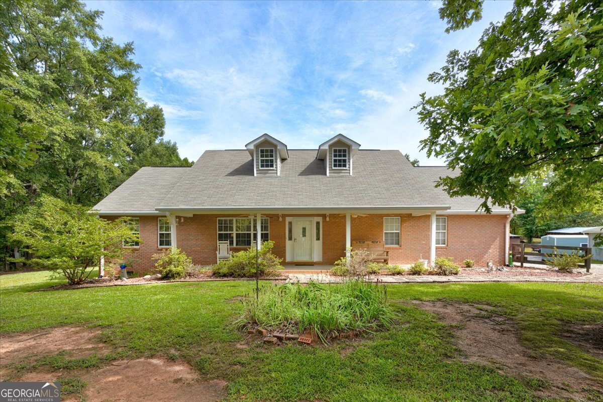 a front view of house with yard and green space