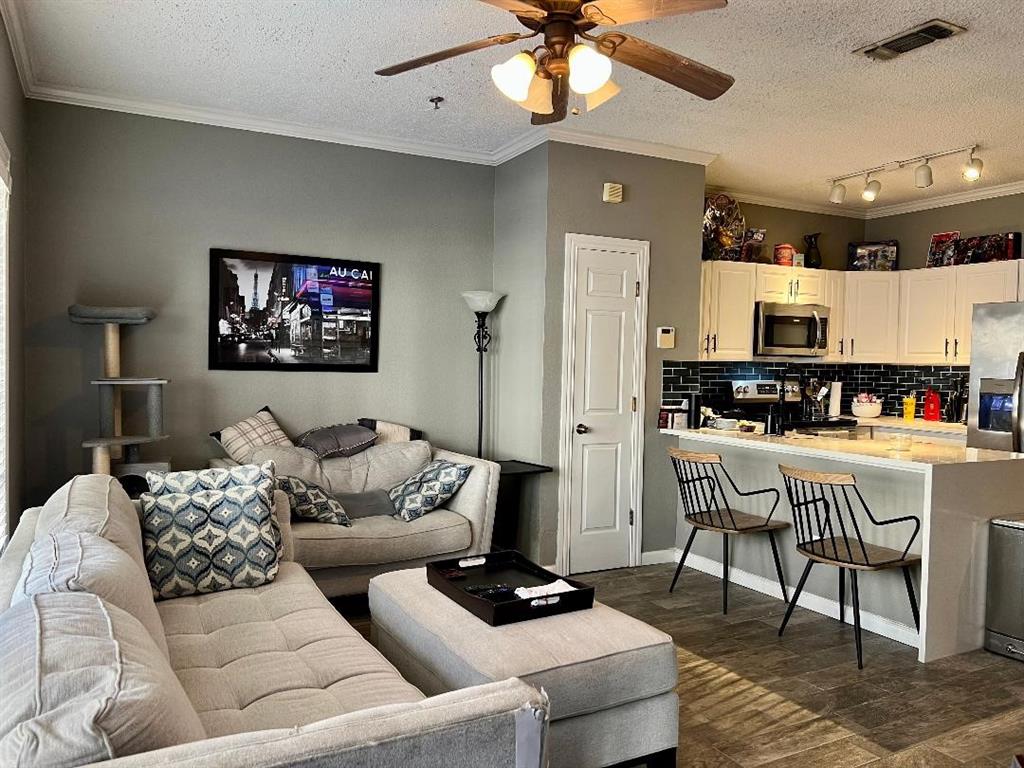 a living room with furniture and kitchen view