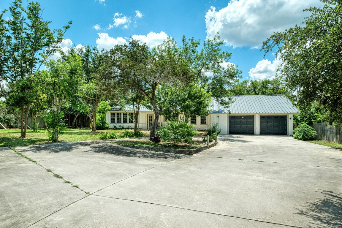 a front view of a house with a yard and a garage