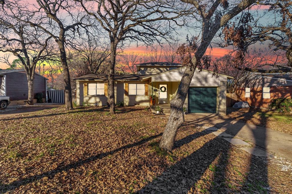 a backyard of a house with barbeque oven table and chairs