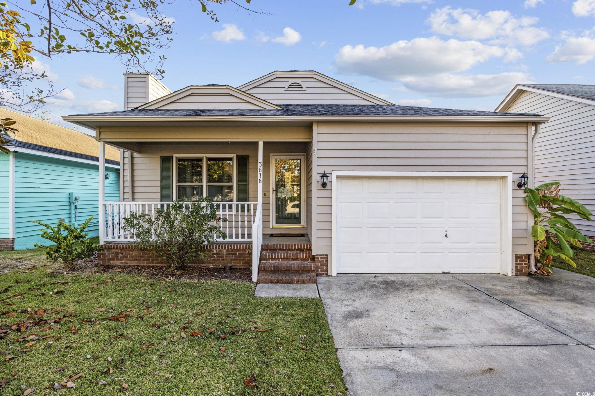 Ranch-style home with a front yard, a porch, and a