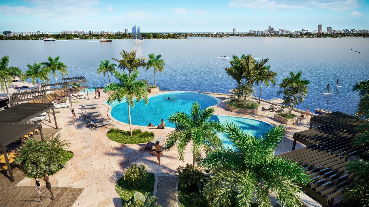 a blue swimming pool with outdoor seating and lake view