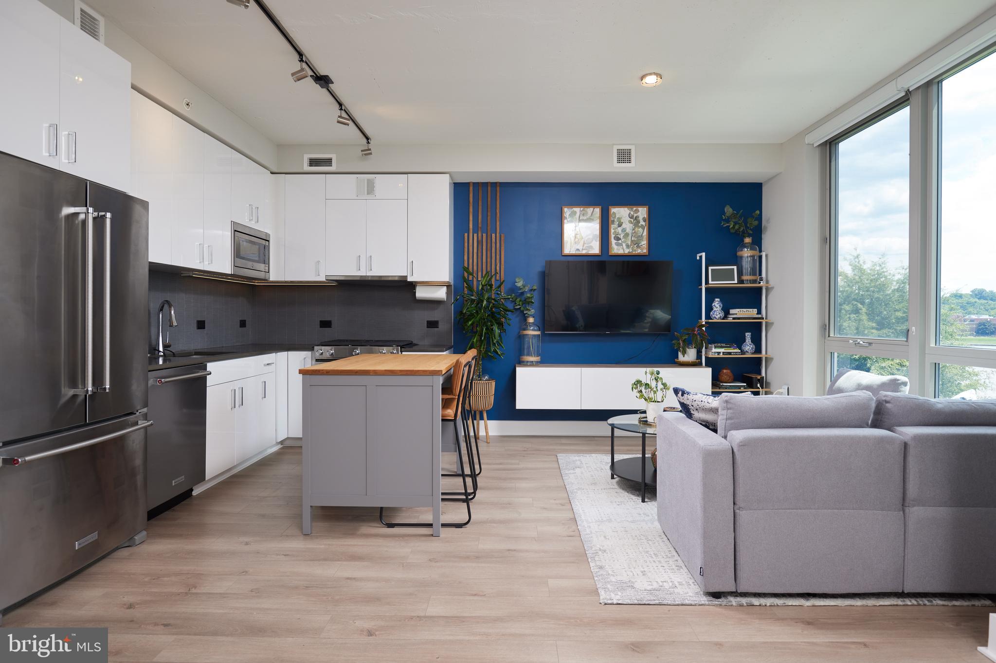 a view of living room kitchen with furniture and appliances