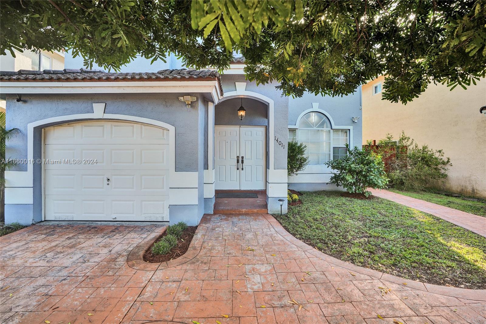 a front view of a house with garden