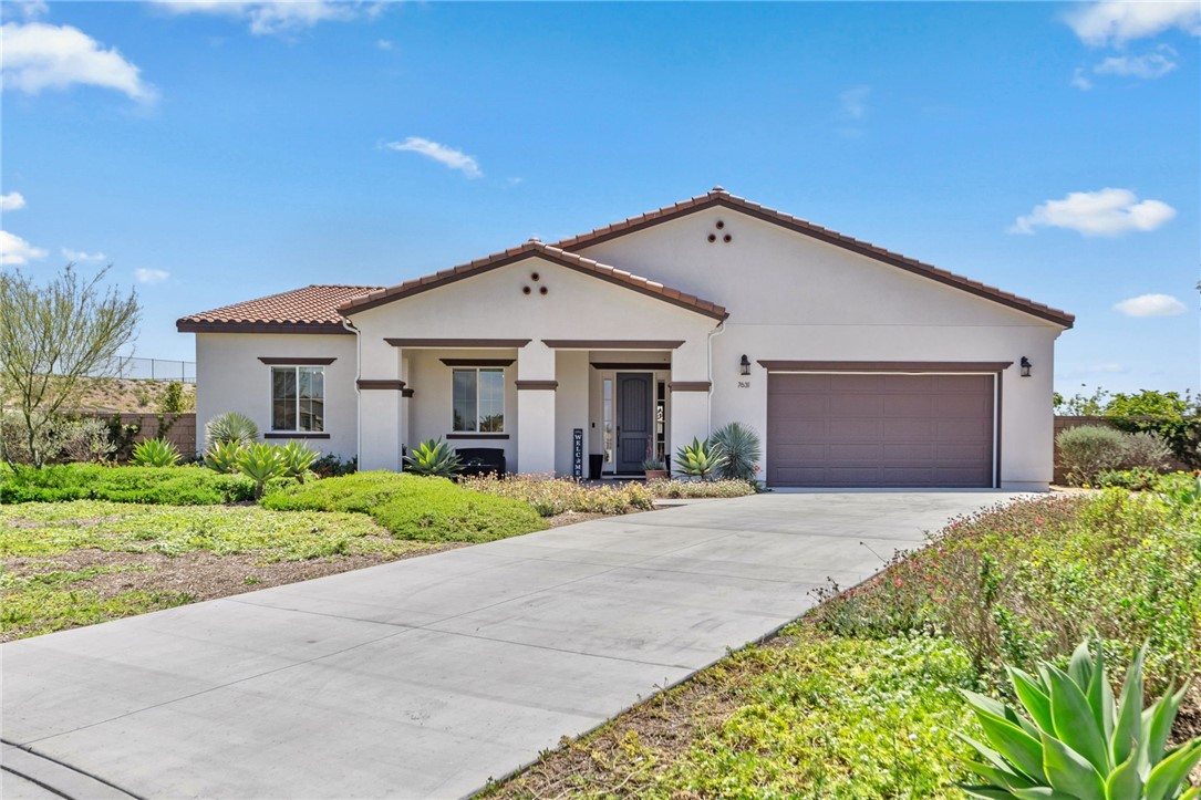 a front view of a house with a yard and garage