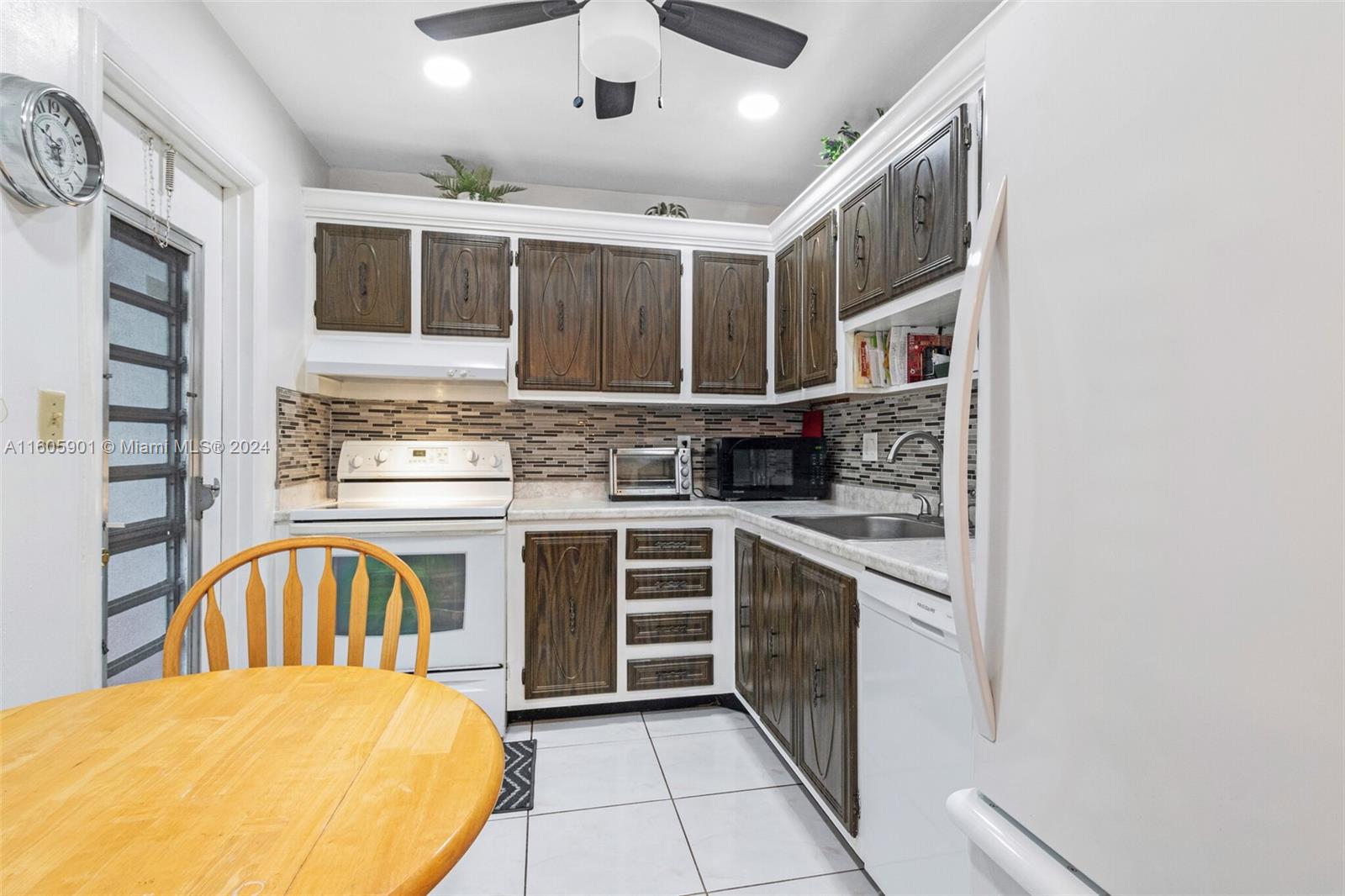 a kitchen with a stove a sink and a refrigerator