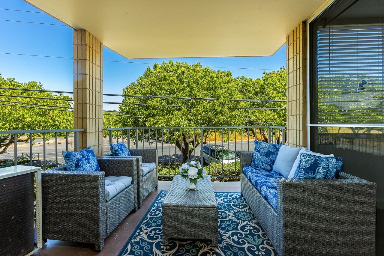 a view of balcony with couches and potted plants