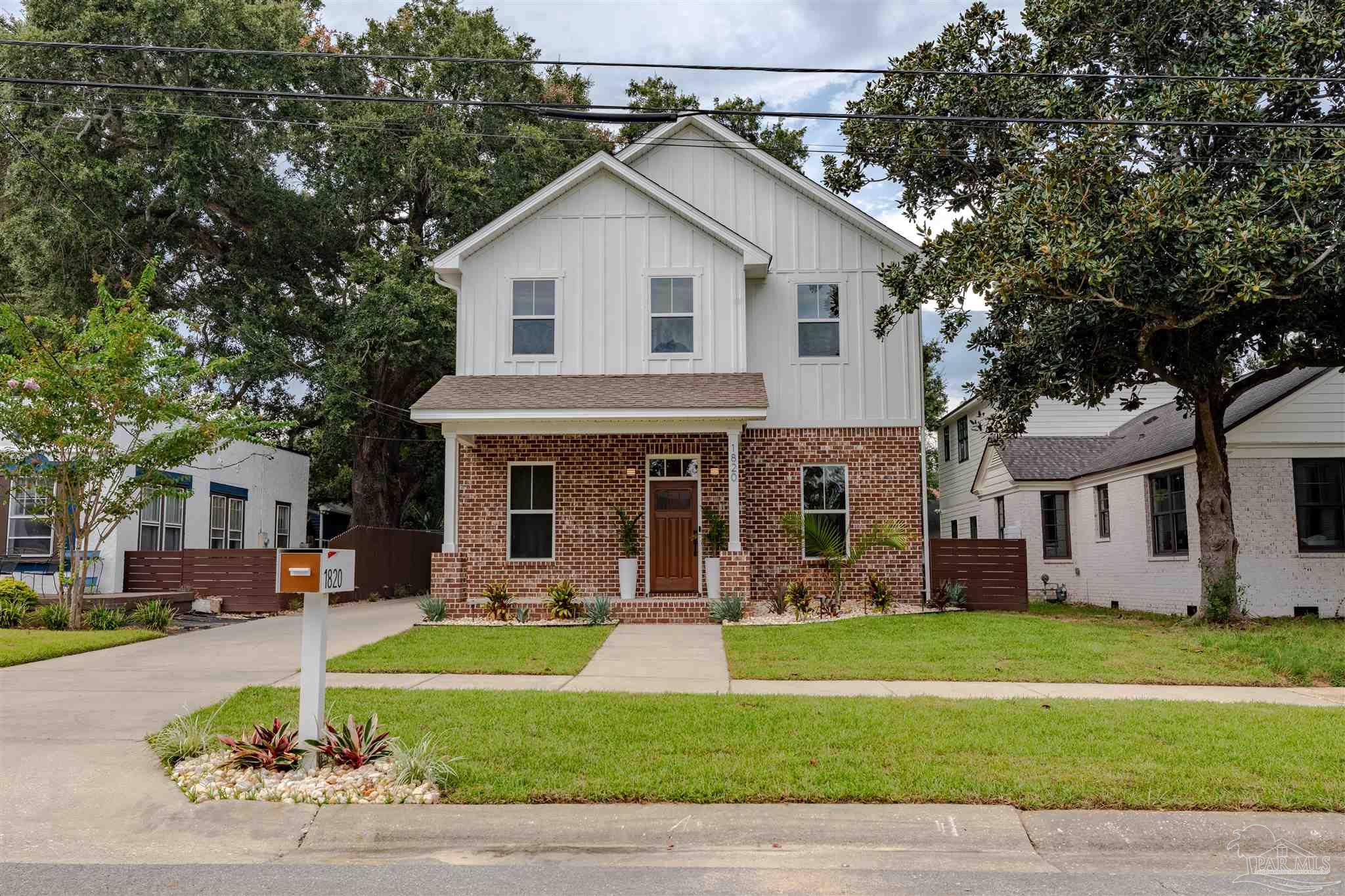 a front view of a house with a yard table and chairs