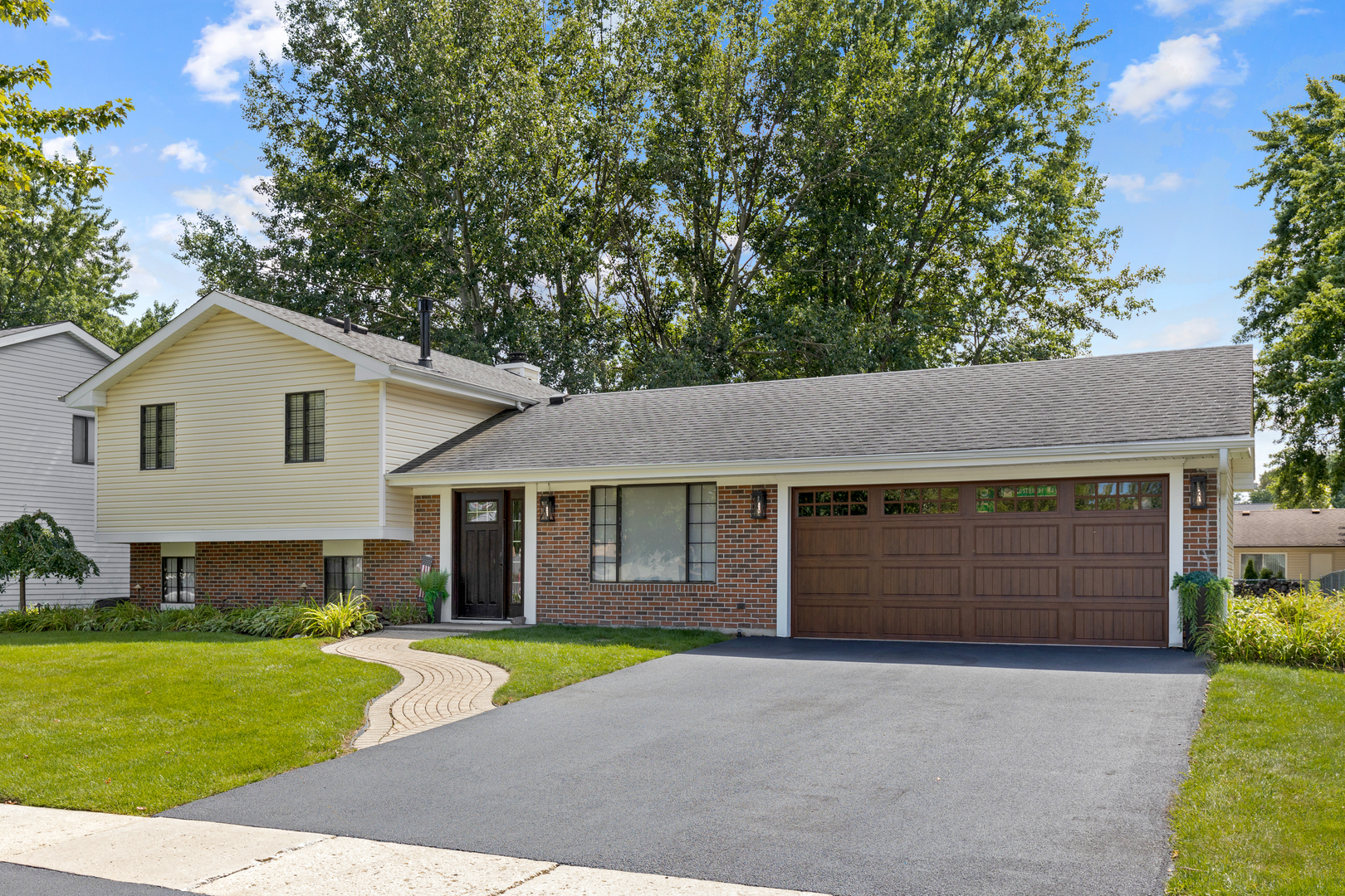 a front view of a house with a yard and garage