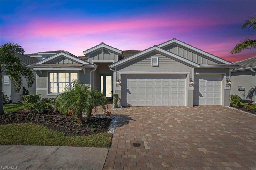 a front view of a house with a yard and garage