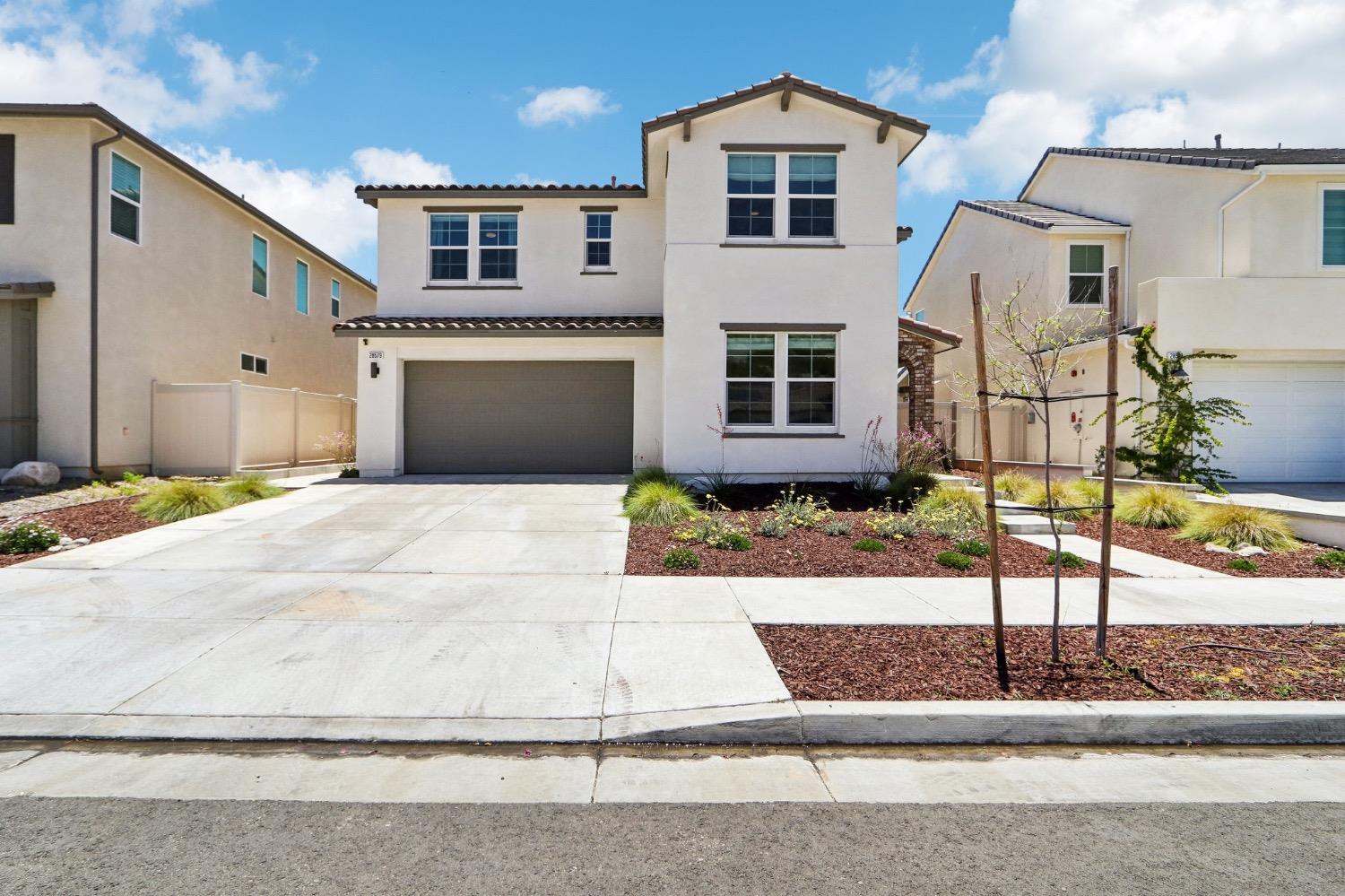 a front view of a house with garage