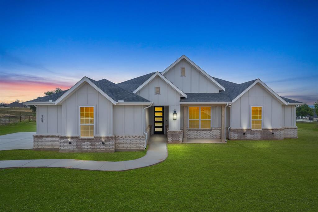 a front view of house with yard and green space